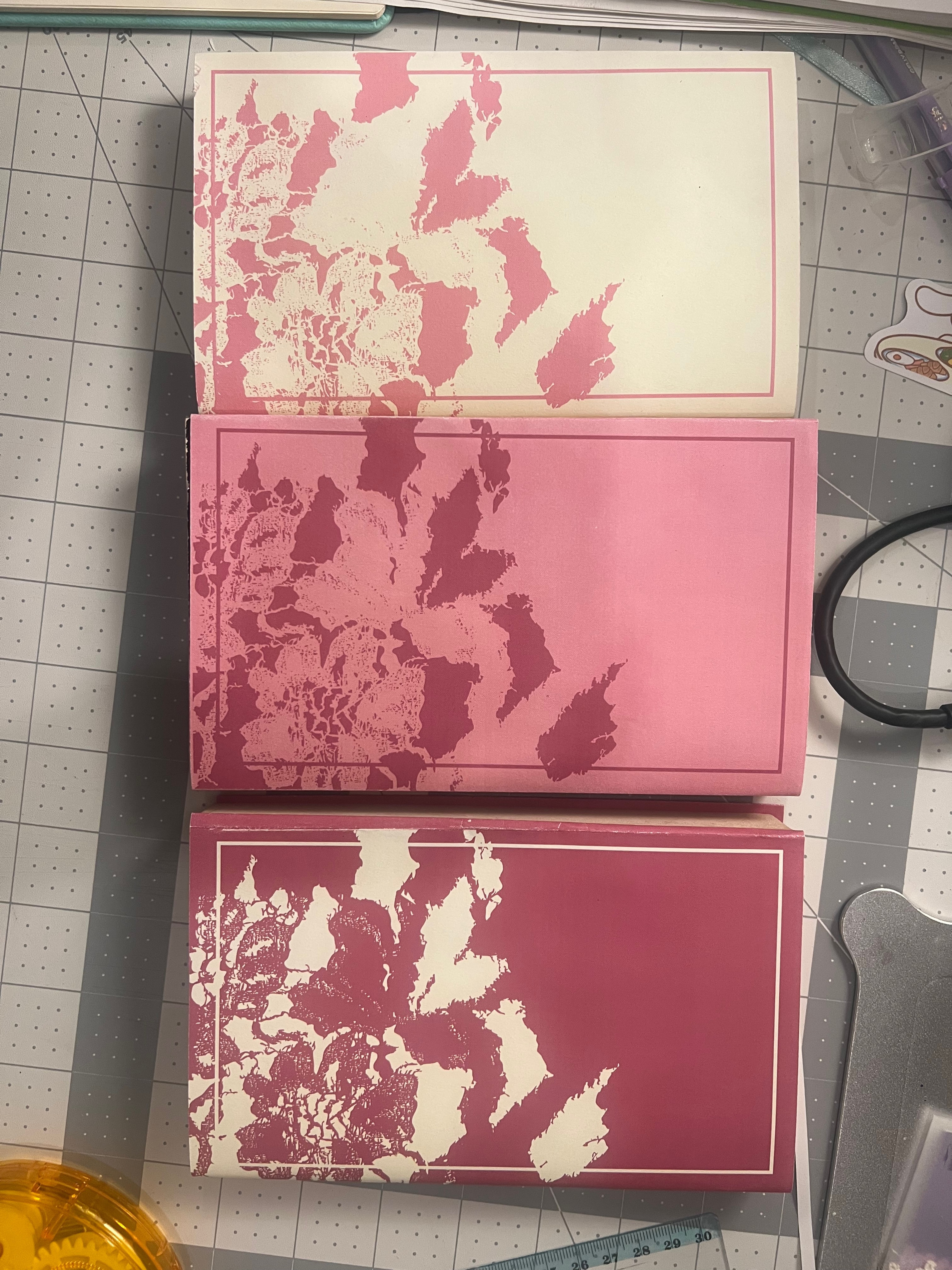 Three book covers on cutting mat